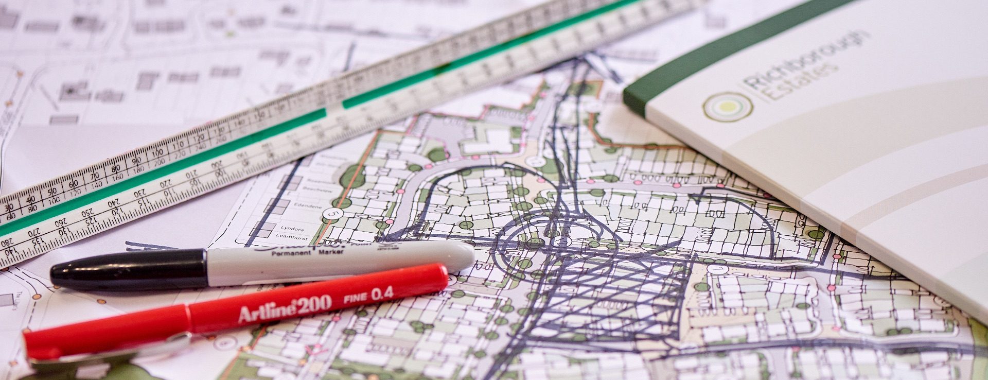 Stationery on top of a site plan.