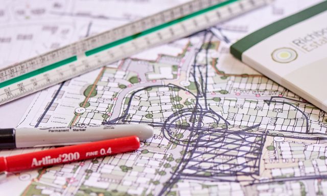 Stationery on top of a site plan.