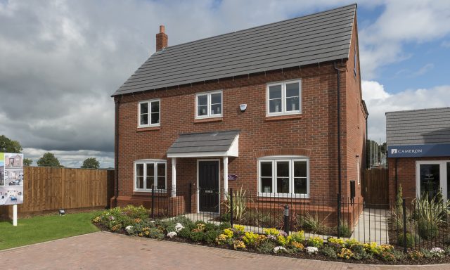 Front facing photo of large new house