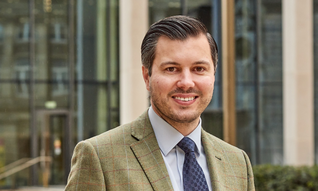 Jordan Gresham man smiling wearing tie and suit