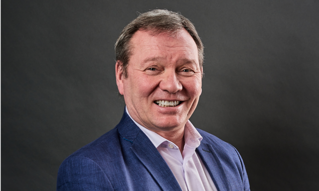 Nick Jones man smiling with teeth wearing suit