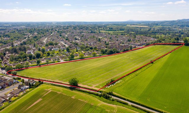 Birds eye photograph of Habberley Road in Kidderminster with large green field and red outline of new project area