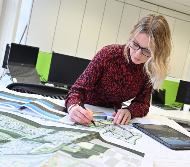 Charlotte Lewis sat down working on commercial land masterplan maps in the Richborough office.