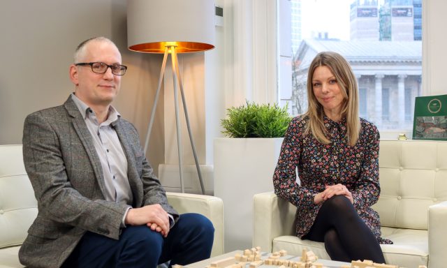 Smiling man and woman in office clothes