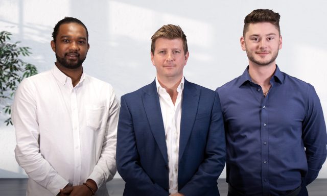 A corporate photo of Spencer Philips, Alex Sciaretta and Harry Rees smiling into the camera to mark the appoitntment of Spencer and Harry