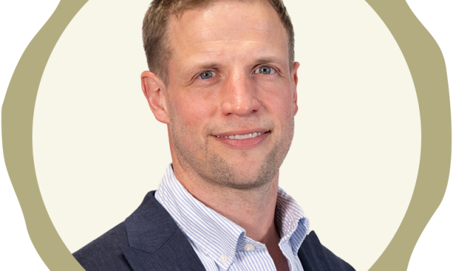 Picture shows a head and shoulder coporate portrait image of Andrew Meikle, in suit jacket and shirt.