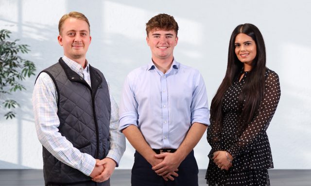 Three smiling staff in office wear Rhys Tupper, Ollie Wilkins and Karuna Bhatia