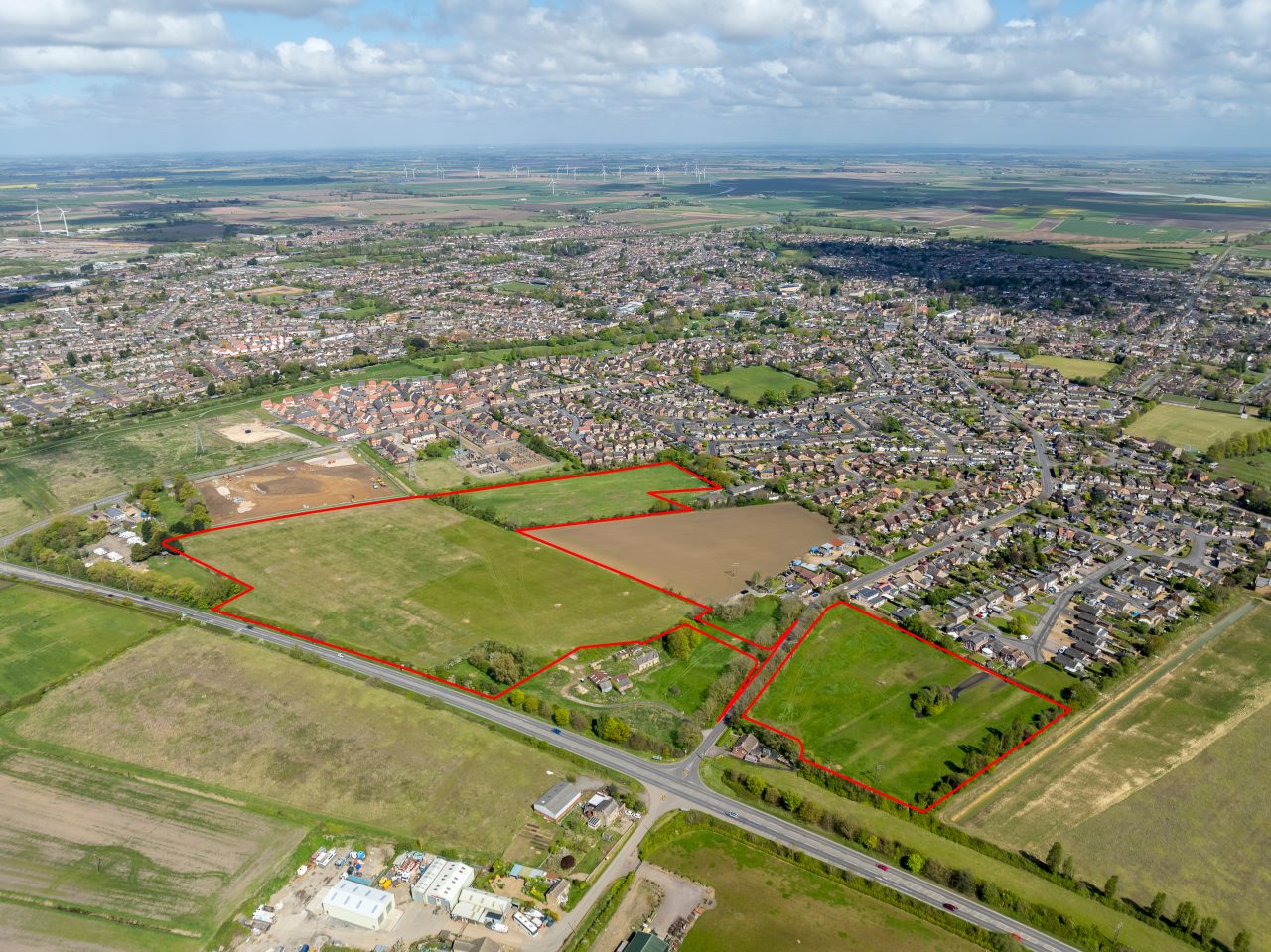 Image shows an aerial photo of land in March with a red line outlining where new homes could go