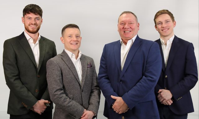 Grroup of smiling men in office clothes from Richborough