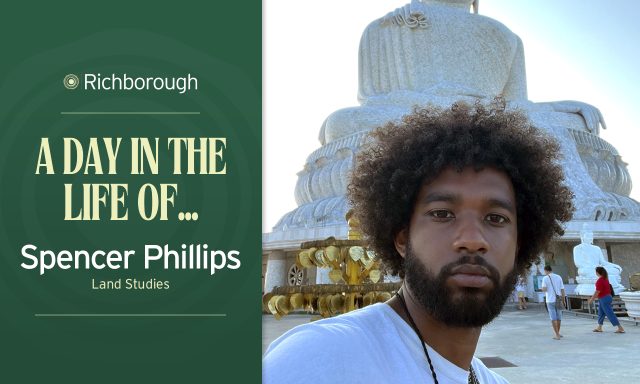 Man in front of Buddhist statue