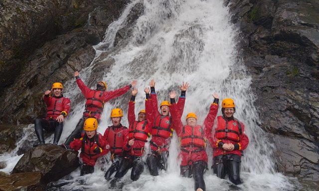 Group of young people on waterfall